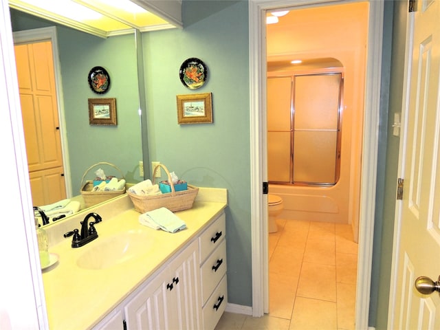 full bathroom featuring tile flooring, shower / bath combination with glass door, toilet, and large vanity