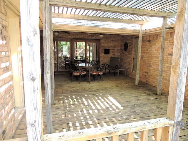 wooden deck with a pergola and french doors