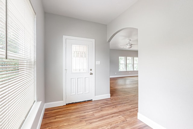 foyer with ceiling fan and light wood-type flooring