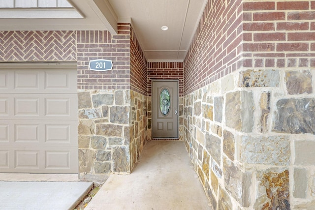 doorway to property with a garage