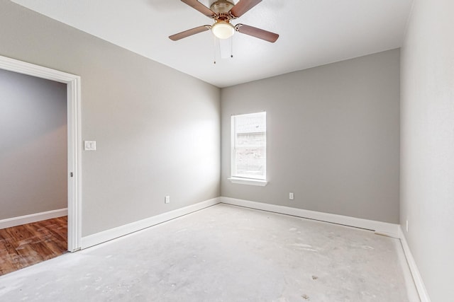 unfurnished room with ceiling fan and concrete floors