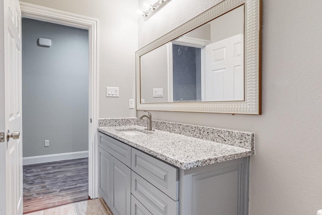 bathroom with hardwood / wood-style flooring and vanity