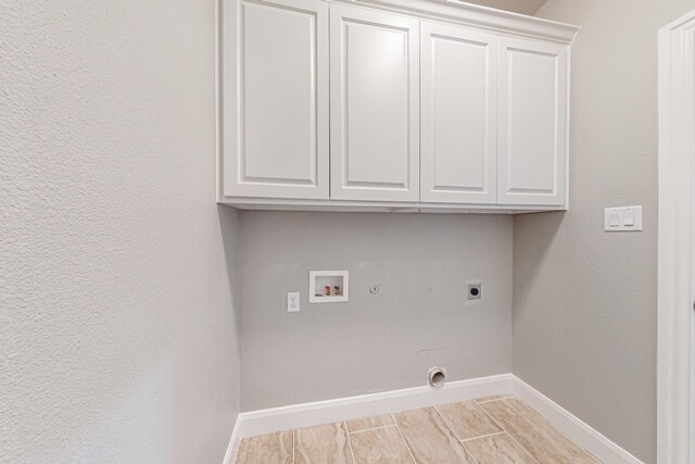 laundry area featuring washer hookup, cabinets, hookup for an electric dryer, and gas dryer hookup