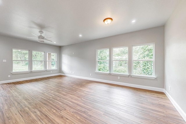 spare room with light wood-type flooring and ceiling fan