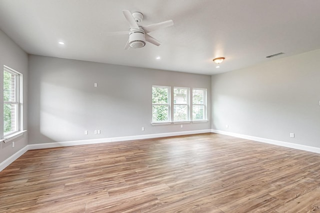 unfurnished room featuring light hardwood / wood-style flooring and ceiling fan