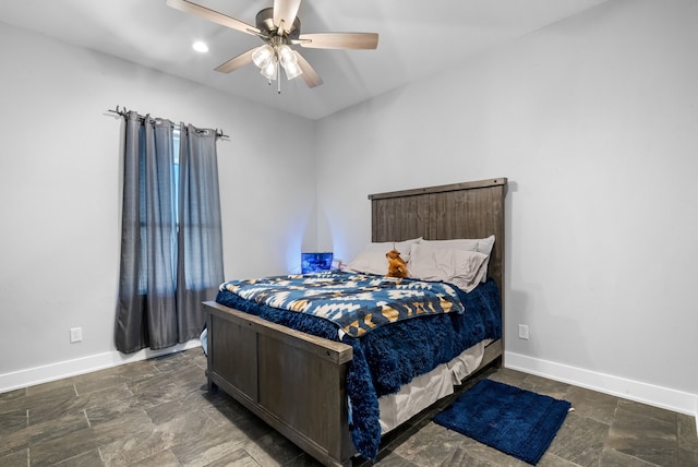 bedroom featuring dark tile flooring and ceiling fan