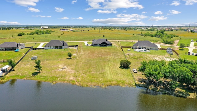 birds eye view of property featuring a water view and a rural view