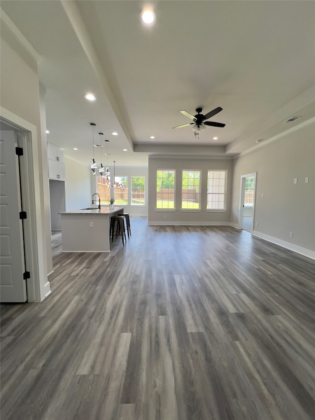 kitchen featuring white cabinets, hardwood / wood-style flooring, a kitchen island with sink, and stainless steel appliances