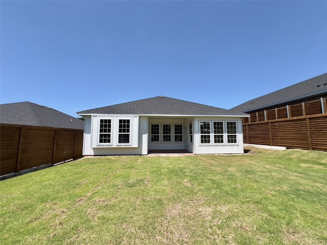 rear view of property with french doors and a lawn