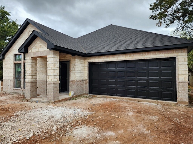 1507 Langston St, Fort Worth, TX 76105 - view of front of house with a shingled roof, an attached garage, brick siding, driveway, and stone siding