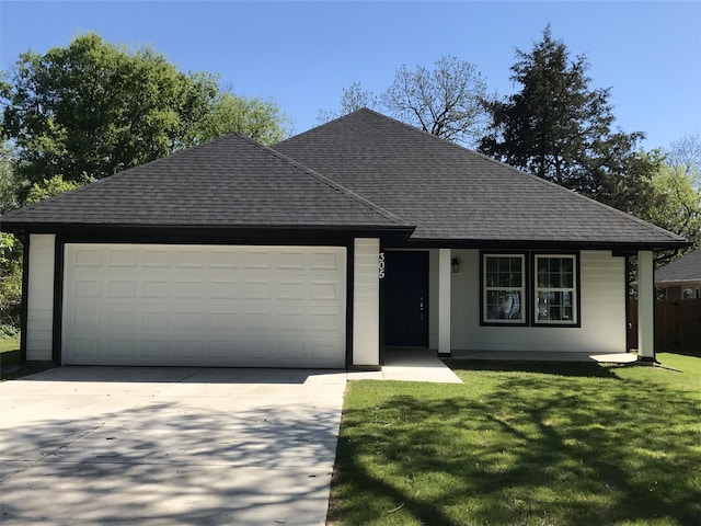 ranch-style house featuring a garage and a front yard