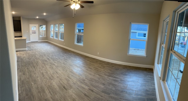 empty room featuring lofted ceiling, ceiling fan, and dark hardwood / wood-style flooring