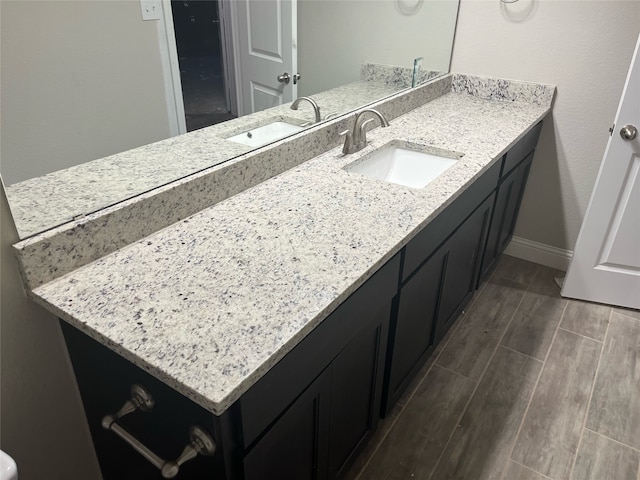 bathroom featuring hardwood / wood-style flooring and oversized vanity