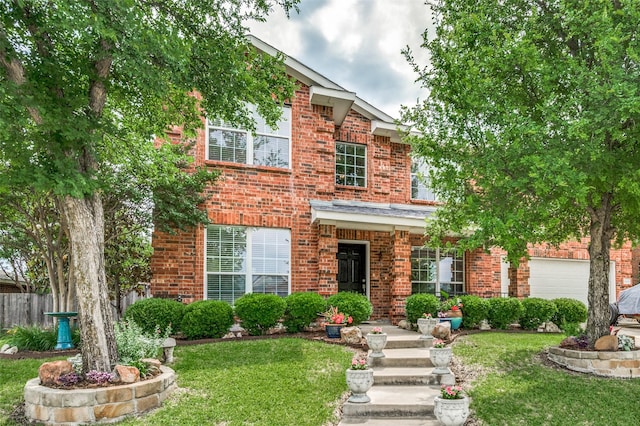 view of front facade with brick siding, a front yard, and fence