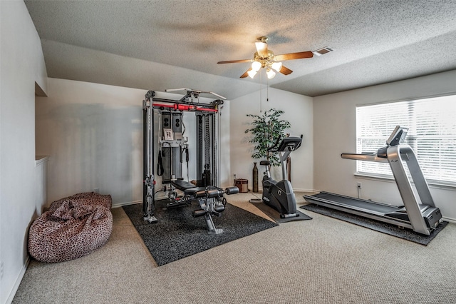 workout room with carpet, a textured ceiling, visible vents, and a ceiling fan