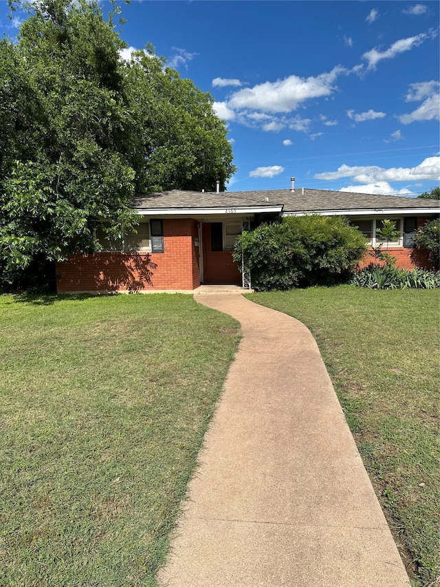 ranch-style house with a front lawn