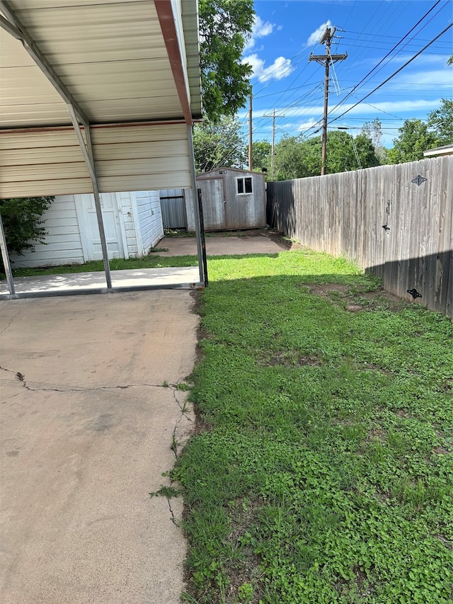 view of yard featuring a patio and a shed