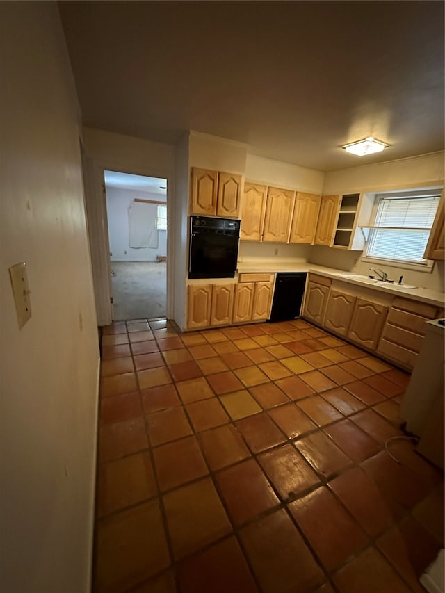 kitchen featuring sink, tile flooring, and black appliances