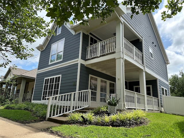 view of side of home featuring a balcony