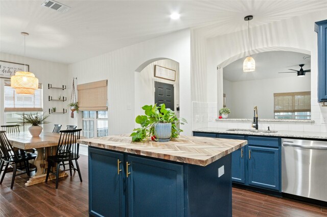 kitchen featuring dishwasher, sink, dark hardwood / wood-style flooring, and blue cabinets