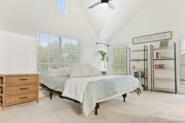 bedroom with high vaulted ceiling, carpet floors, multiple windows, and ceiling fan