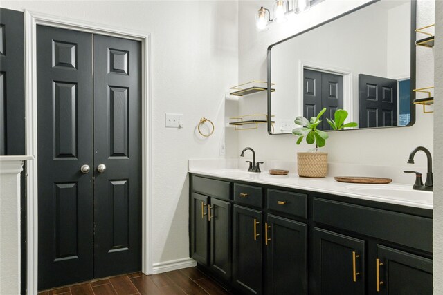 bathroom featuring double vanity and wood-type flooring