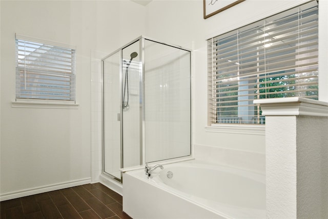 bathroom with a wealth of natural light and separate shower and tub