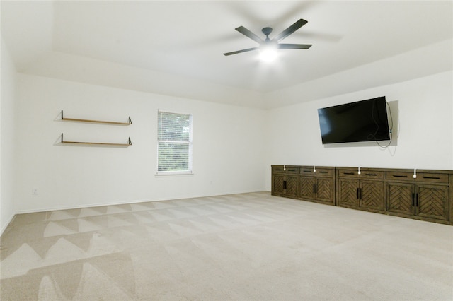 unfurnished living room with carpet and ceiling fan