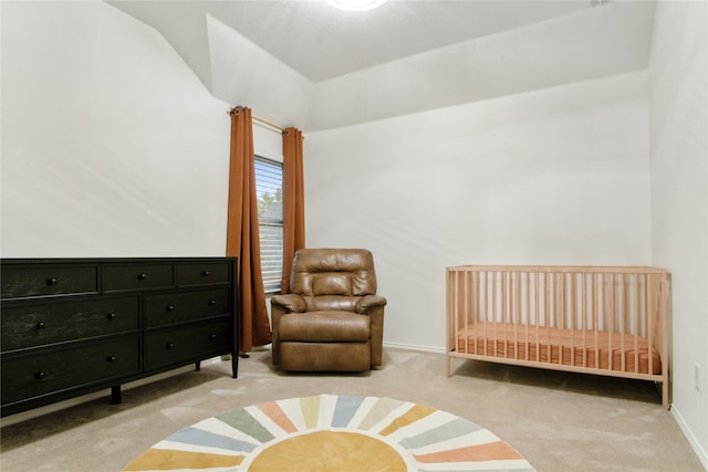 carpeted bedroom featuring a nursery area