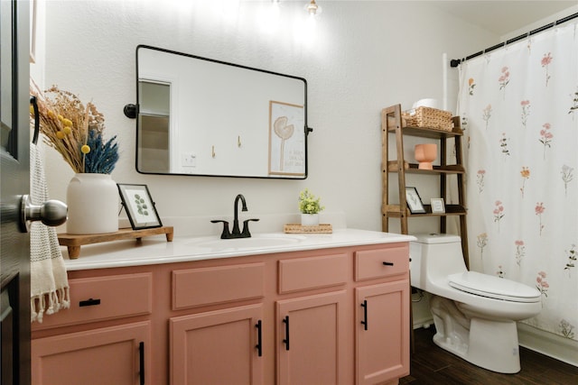 bathroom with vanity, toilet, and hardwood / wood-style floors