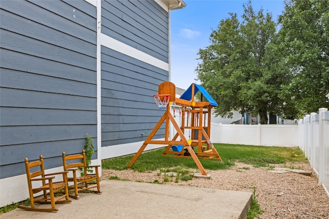 view of jungle gym featuring a lawn