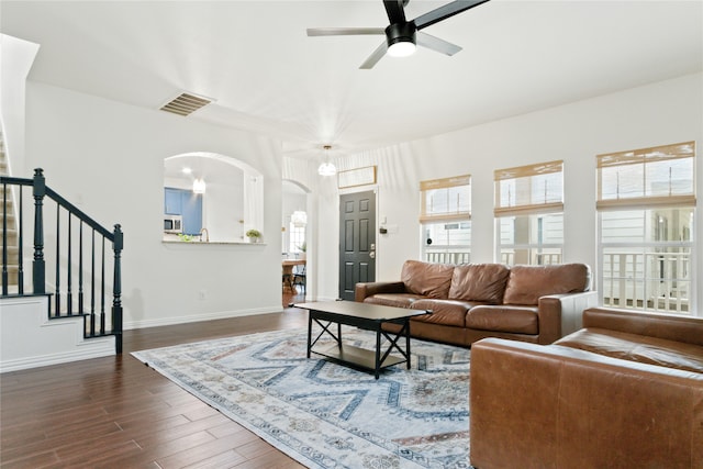 living room featuring dark hardwood / wood-style floors and ceiling fan