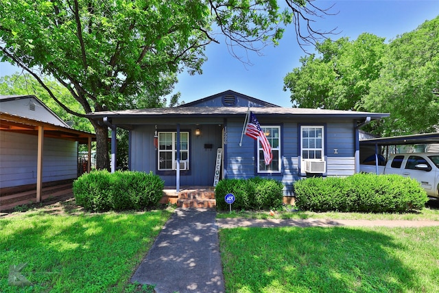 bungalow featuring covered porch, a front lawn, and cooling unit