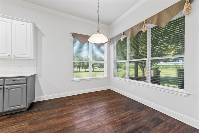 unfurnished dining area featuring crown molding and dark hardwood / wood-style flooring