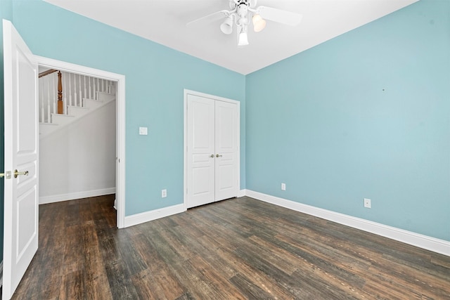 unfurnished bedroom with a closet, ceiling fan, and dark hardwood / wood-style flooring