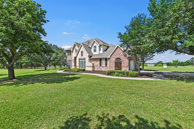 view of front of property featuring a garage and a front yard