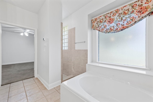 bathroom featuring tile floors, a bathtub, and ceiling fan