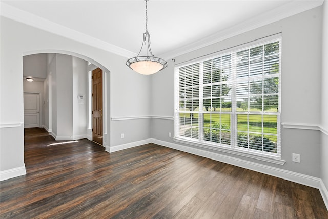 spare room featuring ornamental molding and dark hardwood / wood-style floors