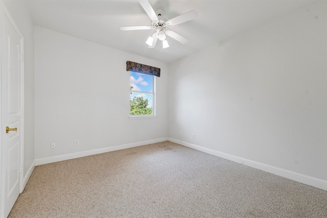 carpeted spare room with ceiling fan