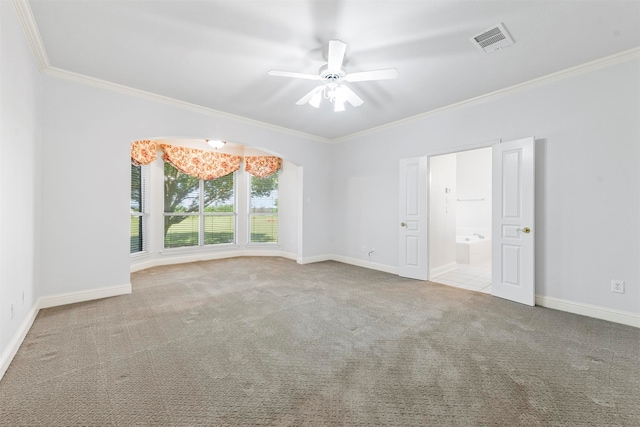 carpeted spare room with crown molding and ceiling fan