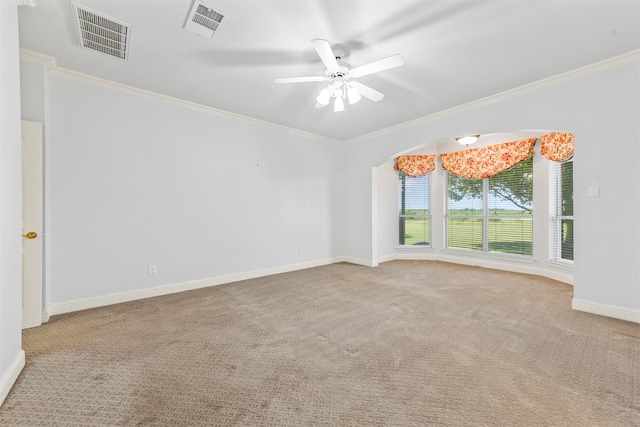 carpeted spare room featuring ceiling fan and crown molding