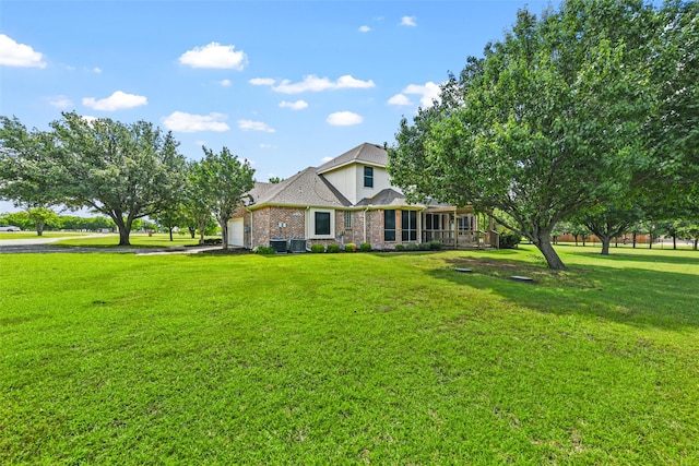 view of front of property featuring a garage and a front lawn