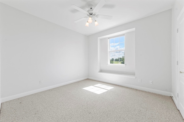 empty room featuring light colored carpet and ceiling fan