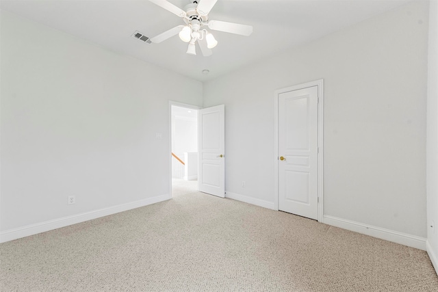 carpeted spare room with ceiling fan