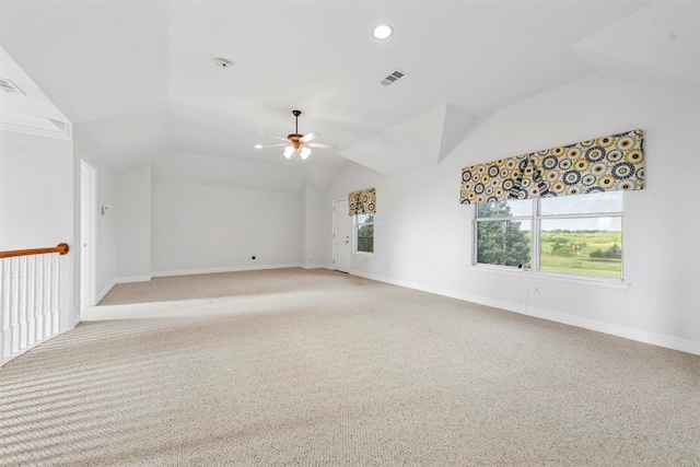 carpeted spare room with vaulted ceiling and ceiling fan