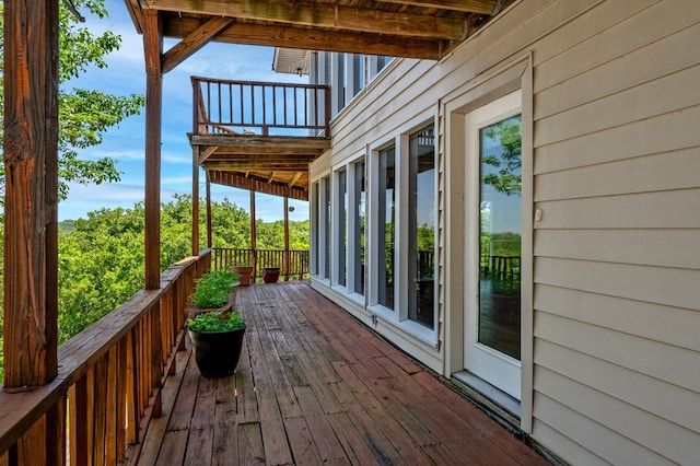 rear view of house featuring a wooden deck