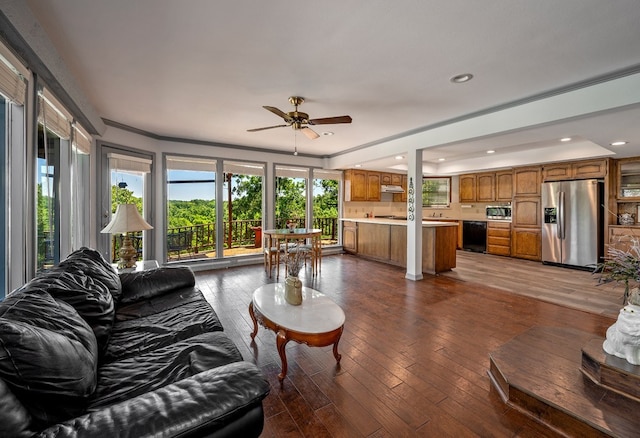 kitchen featuring kitchen peninsula, appliances with stainless steel finishes, sink, and a tray ceiling