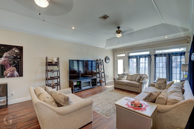 living room featuring french doors, dark hardwood / wood-style floors, a raised ceiling, ceiling fan, and crown molding