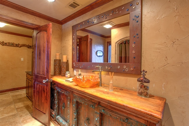 bathroom with tile flooring, crown molding, and oversized vanity