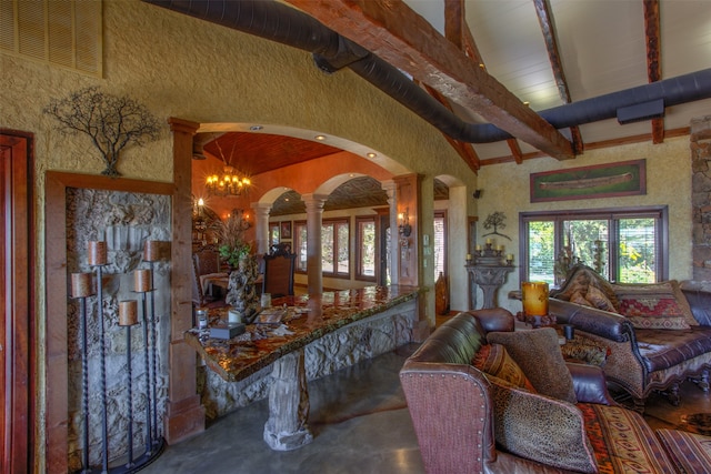 living room with ornate columns, beamed ceiling, wood ceiling, a notable chandelier, and high vaulted ceiling